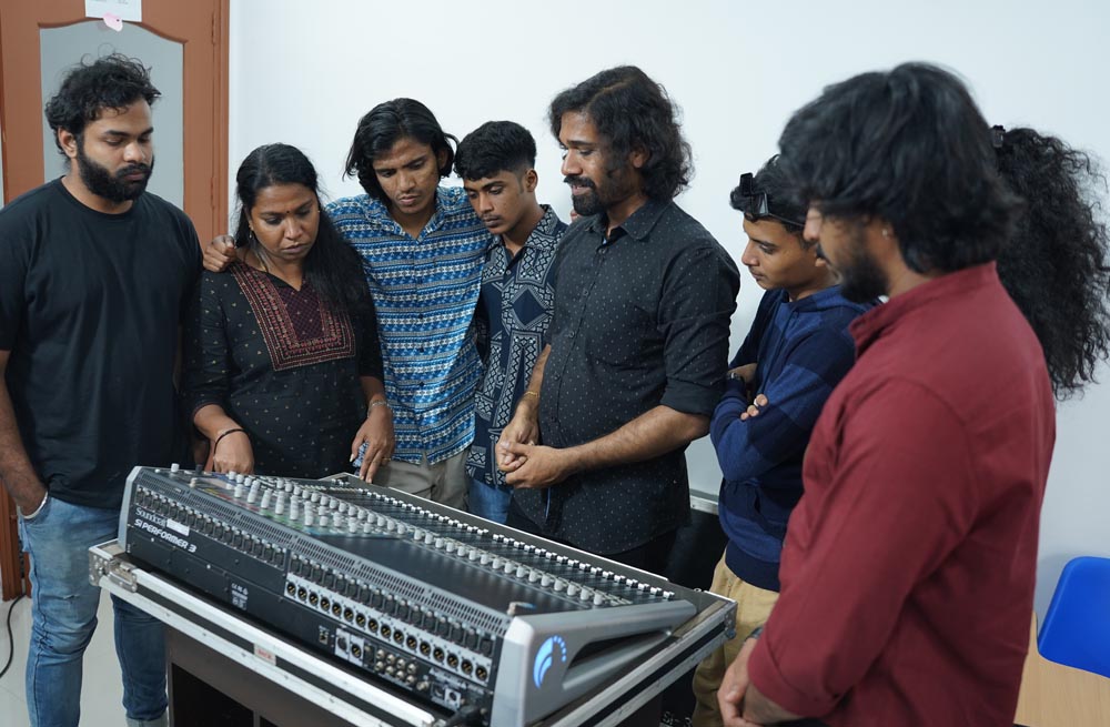 Sound engineering students learning on digital mixer