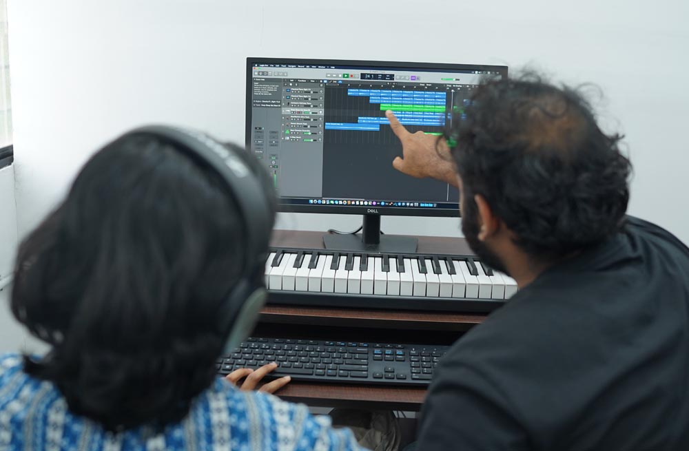 Sound engineering students exploring music production